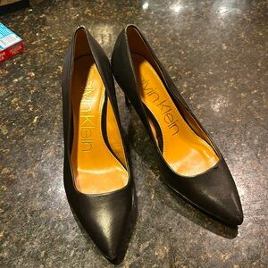 Like new black Calvin Klein pumps with gold metal plate on heel seam.  4” heels